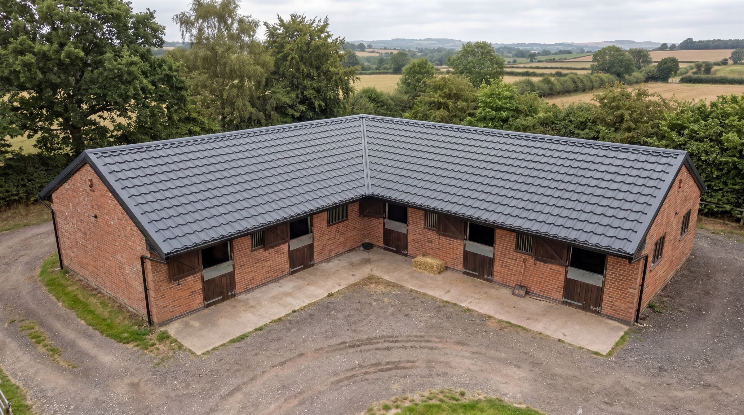 UK stable block with anthracite Mighty Structural pan-tile metal roofing sheets